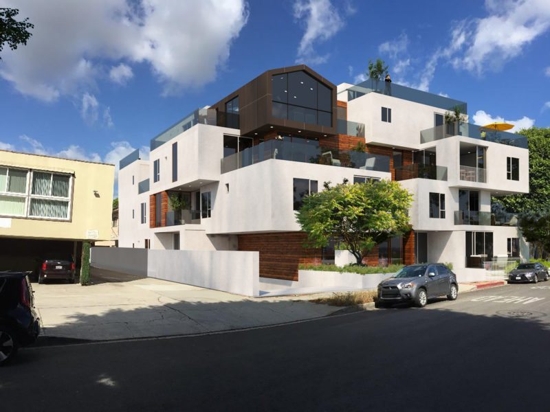 Modern white residential building with balconies and dark accents under a blue sky.
