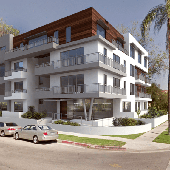Modern multi-story apartment building with balconies and surrounding greenery.