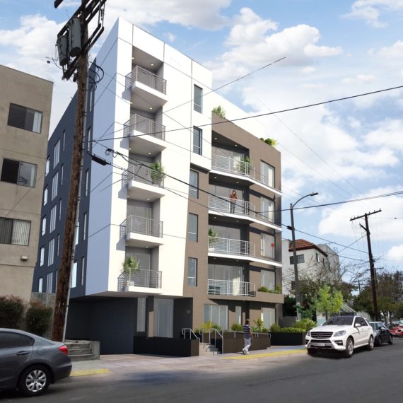 Modern multi-story apartment building with balconies and parked cars.