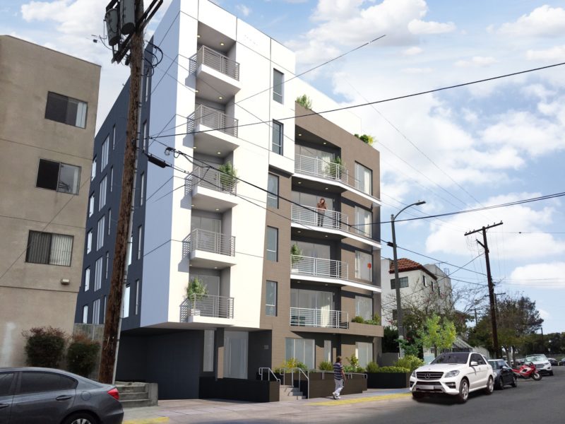 Modern multi-story apartment building with balconies and parked cars.