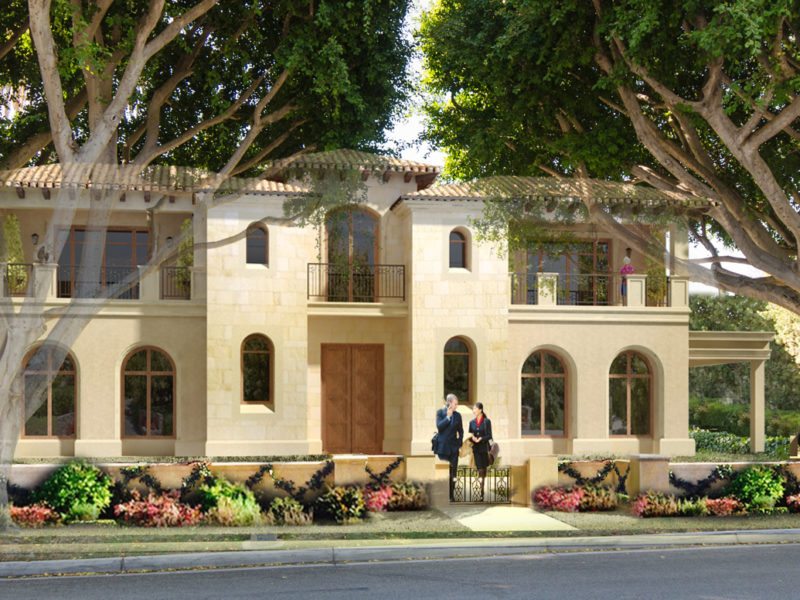 A two-story house with beige walls surrounded by trees and flowers.