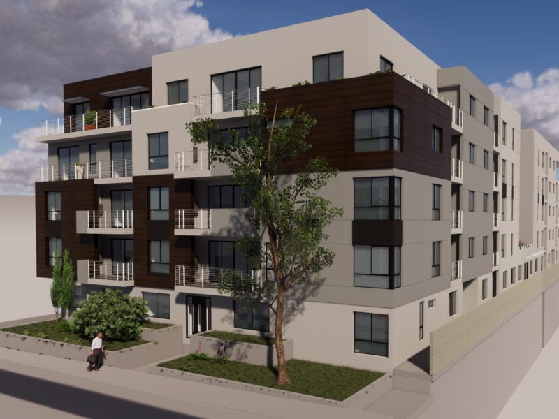 Modern multi-story apartment building with balconies and large windows.