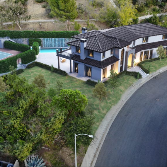 Modern two-story house with a landscaped garden and swimming pool.