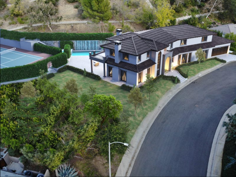 Modern two-story house with a landscaped garden and swimming pool.