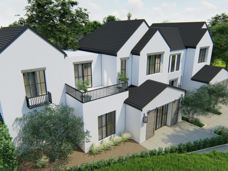 Modern white houses with black roofs and balconies in a green setting.